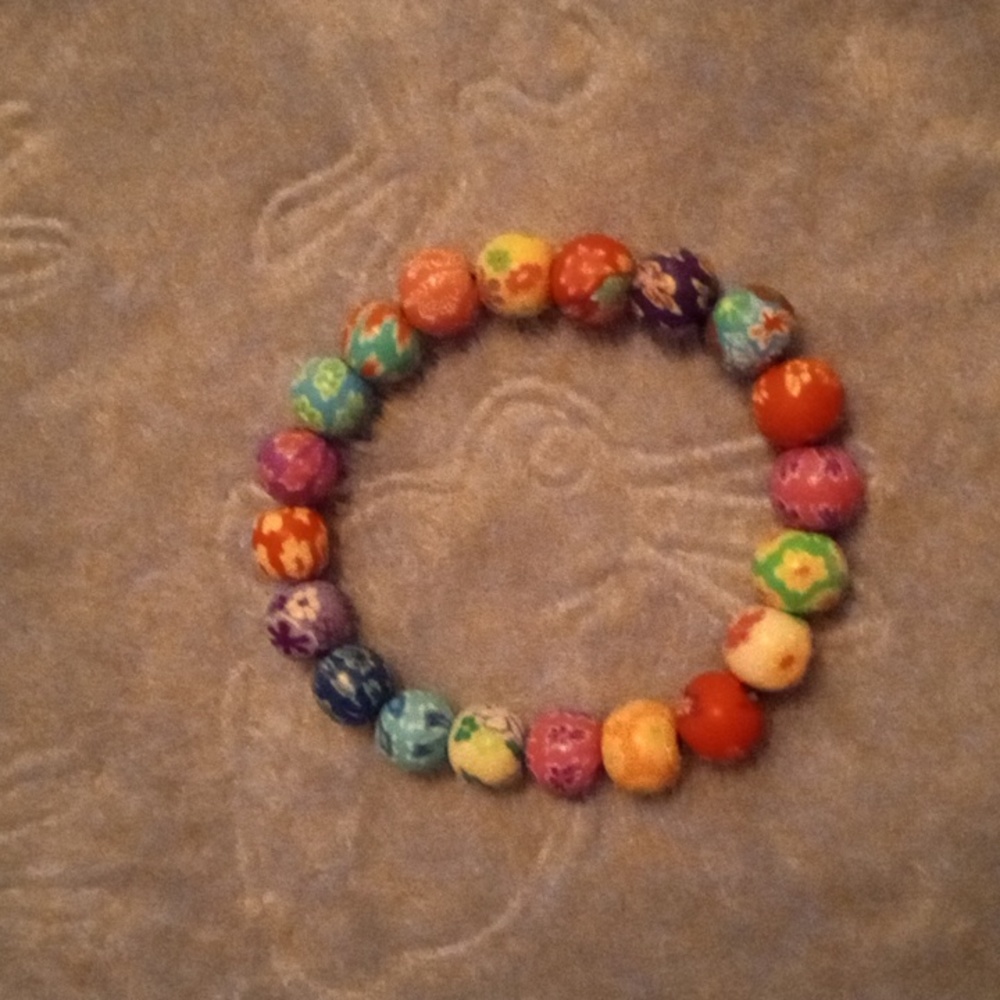 Handmade multicolored clay beaded bracelet with floral abstract designs